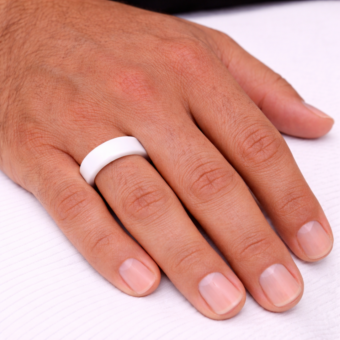 Man wearing Twinn classic white ceramic contactless payment ring