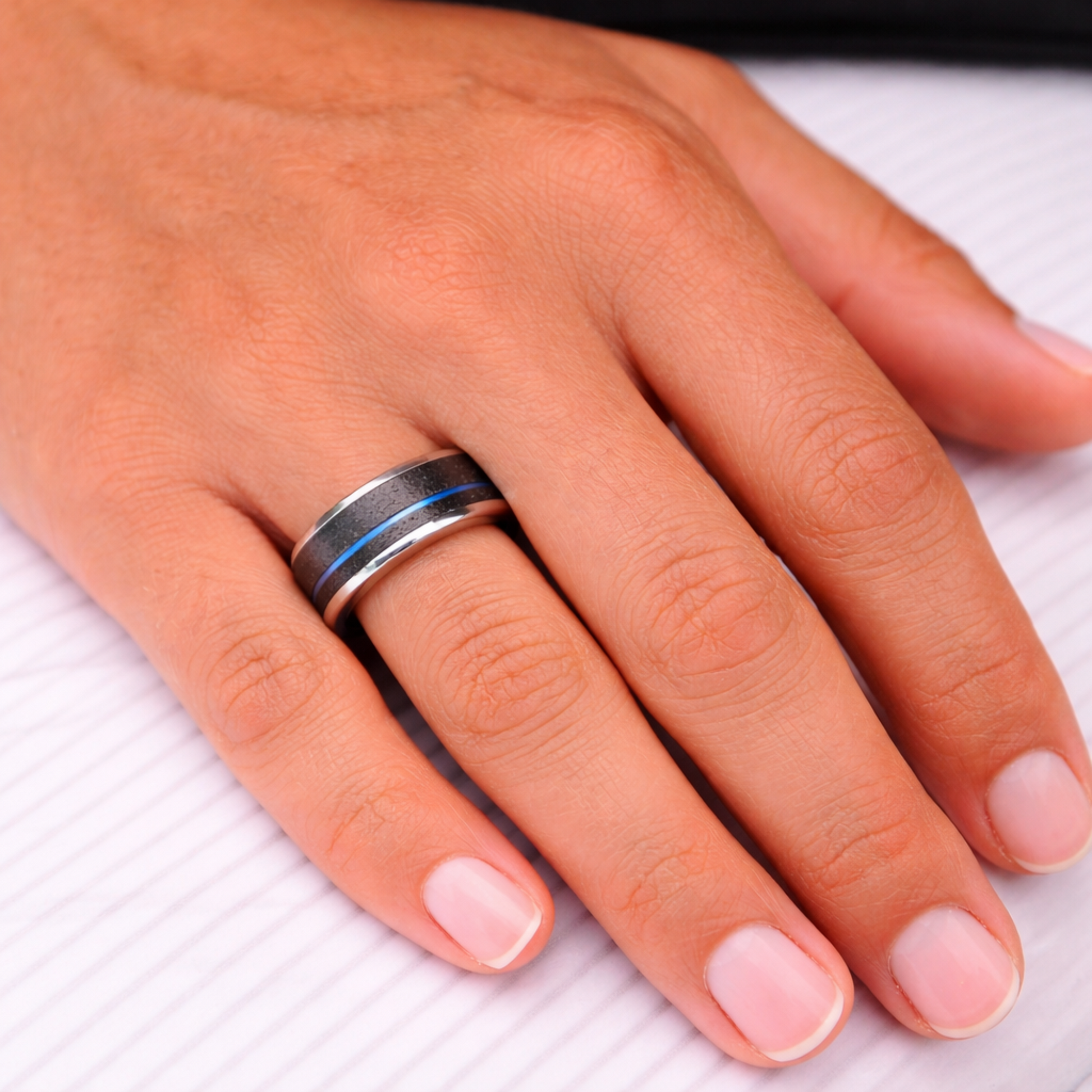 Woman wearing Twinn Metal Blue contactless payment ring