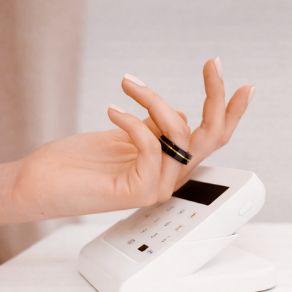 Person paying with Twinn Metal Gold Silver contactless payment ring